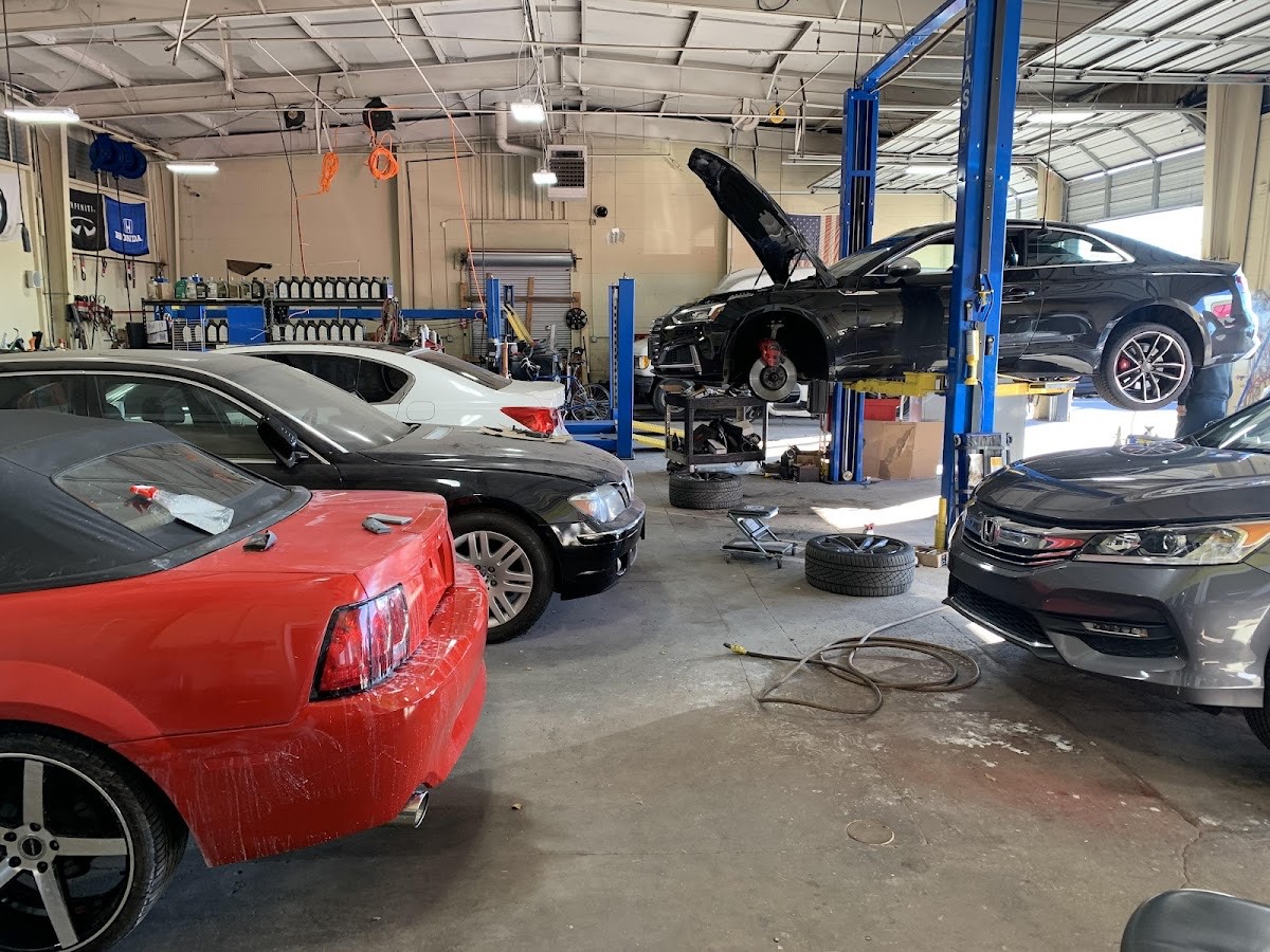 Cars up on the lifts in the service bay at American Tire Lube & Automotive