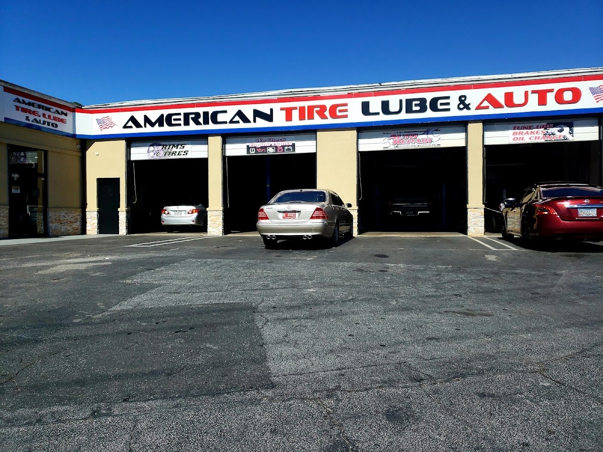 American Tire Lube & Automotive storefront at 3518 Memorial Dr, Decatur GA, with three open service bays